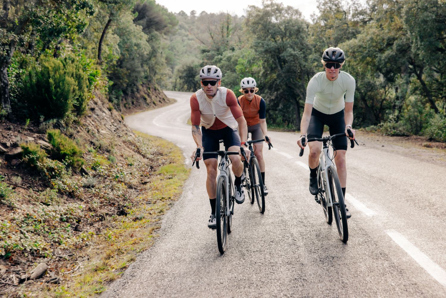 Three people riding bicycles
