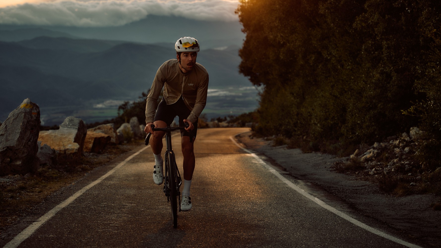 Man riding a road bike at dusk
