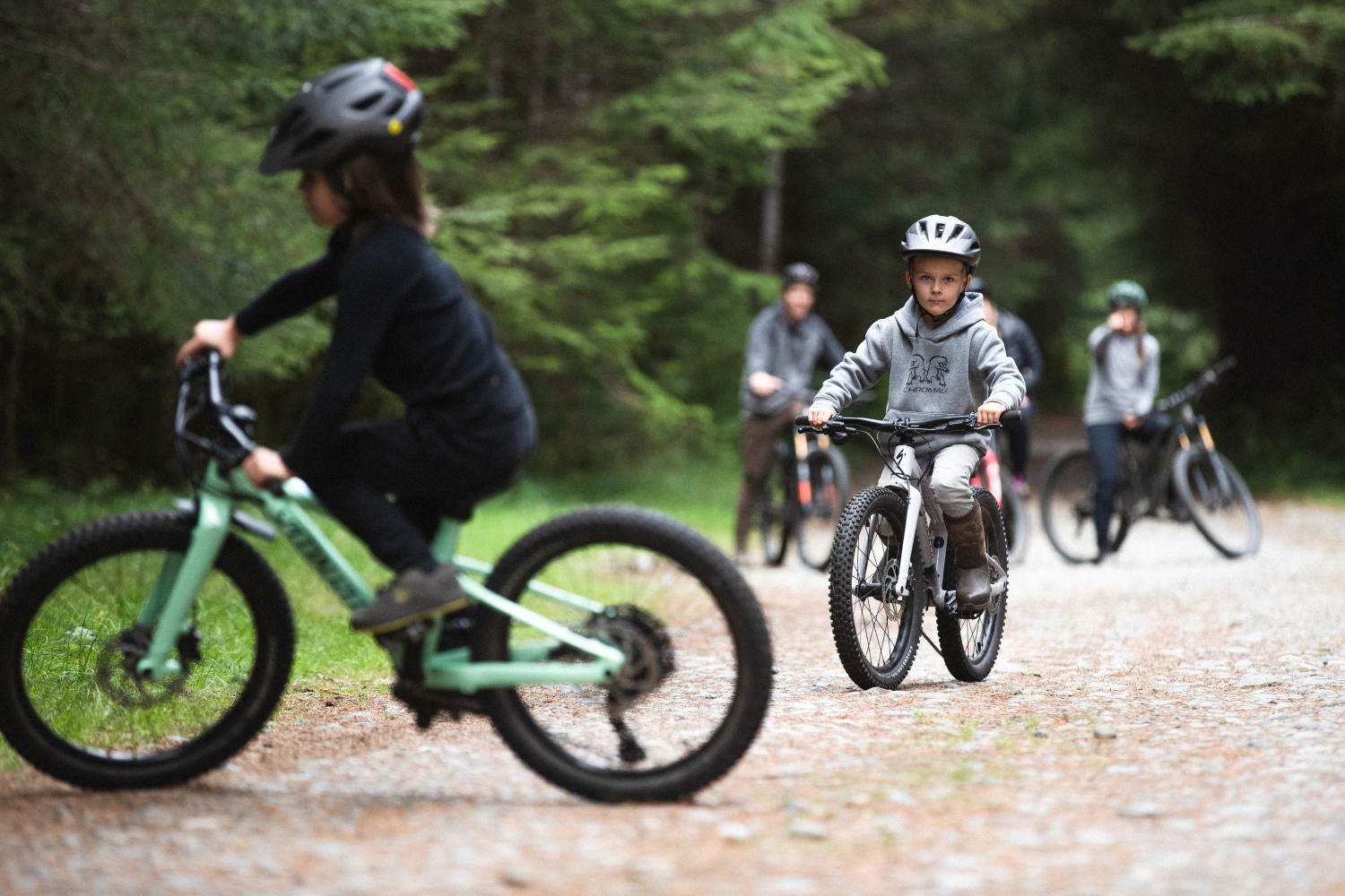 Vaikai miške važinėjantys dviračiais