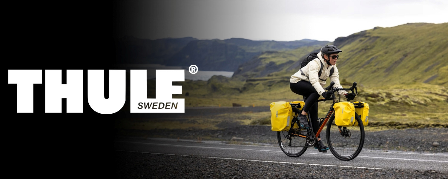 Cyclist riding a touring bike with panniers