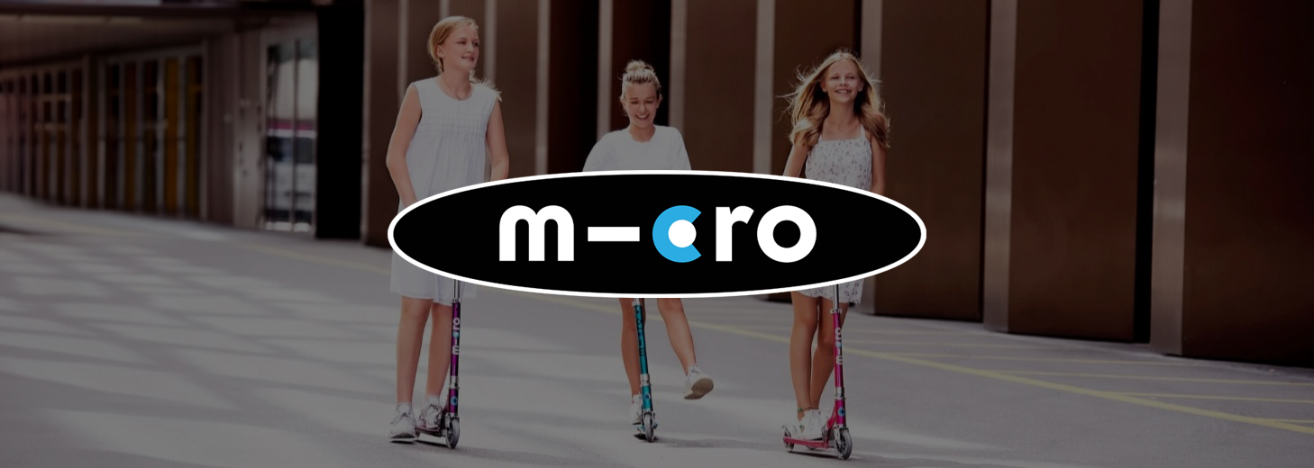 Three girls riding scooters