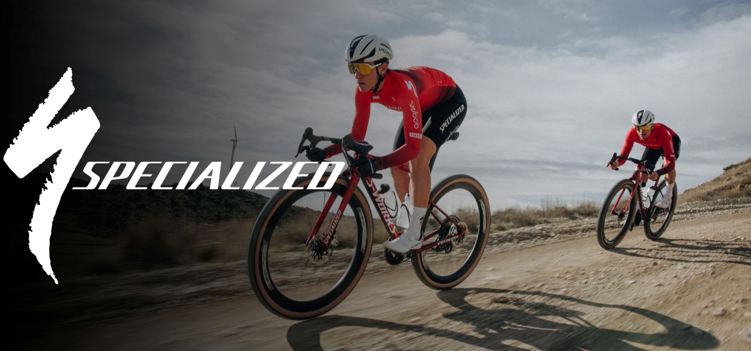 Two cyclists riding gravel bikes on a gravel road