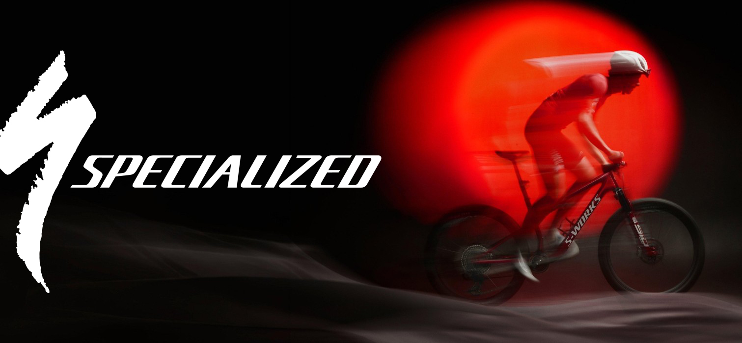 MTB rider with bike on dark background